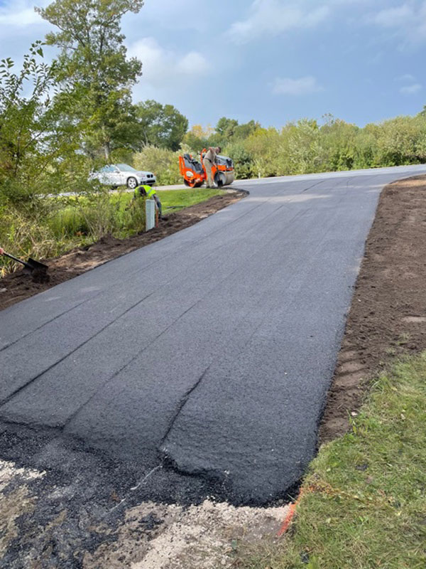 Driveway blacktop after being rolled