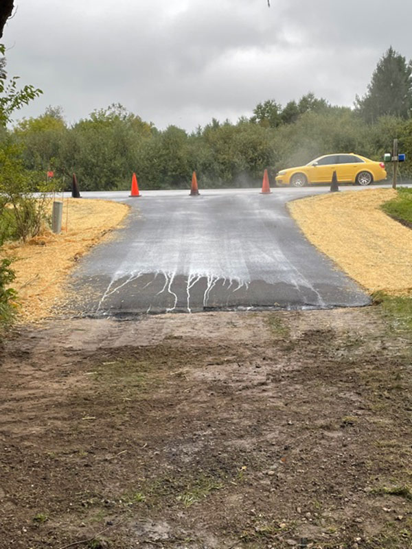 Driveway after blacktop poured and rolled